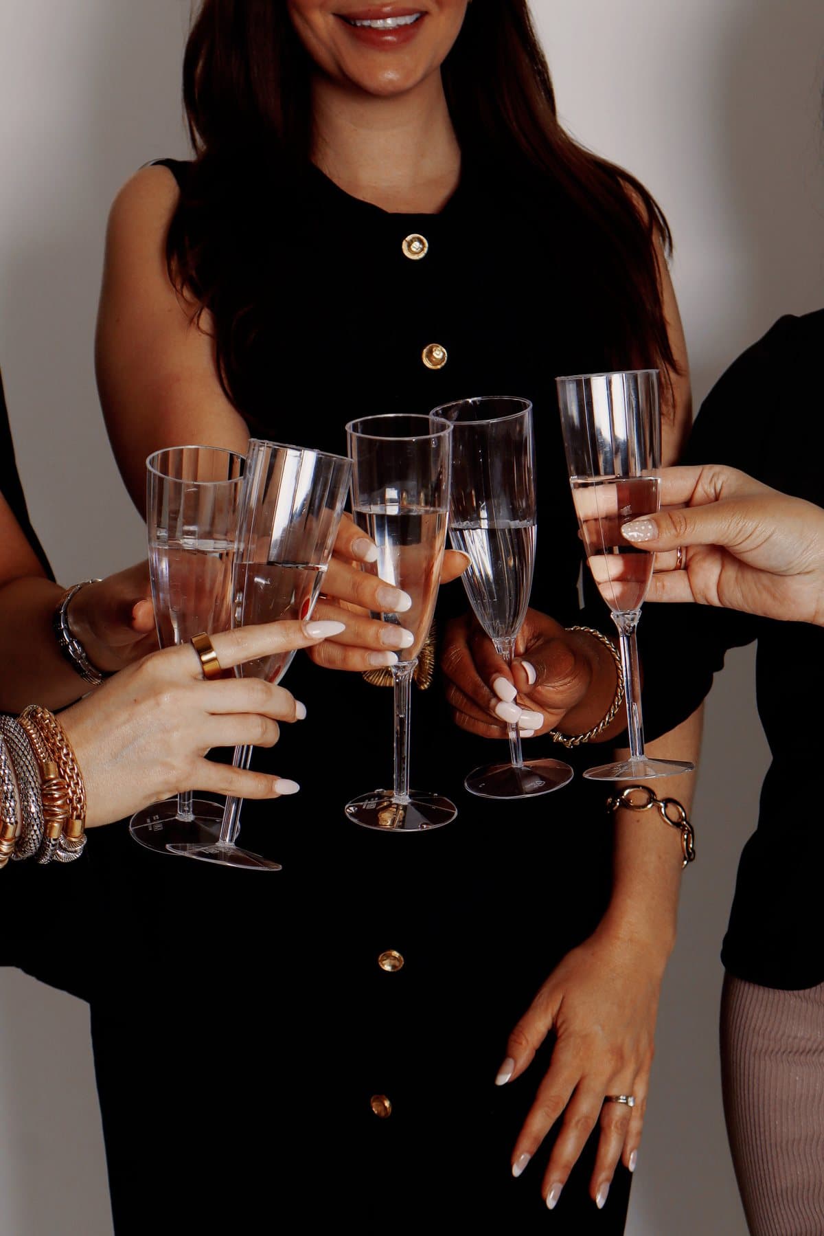 The team in black raising champagne flutes together